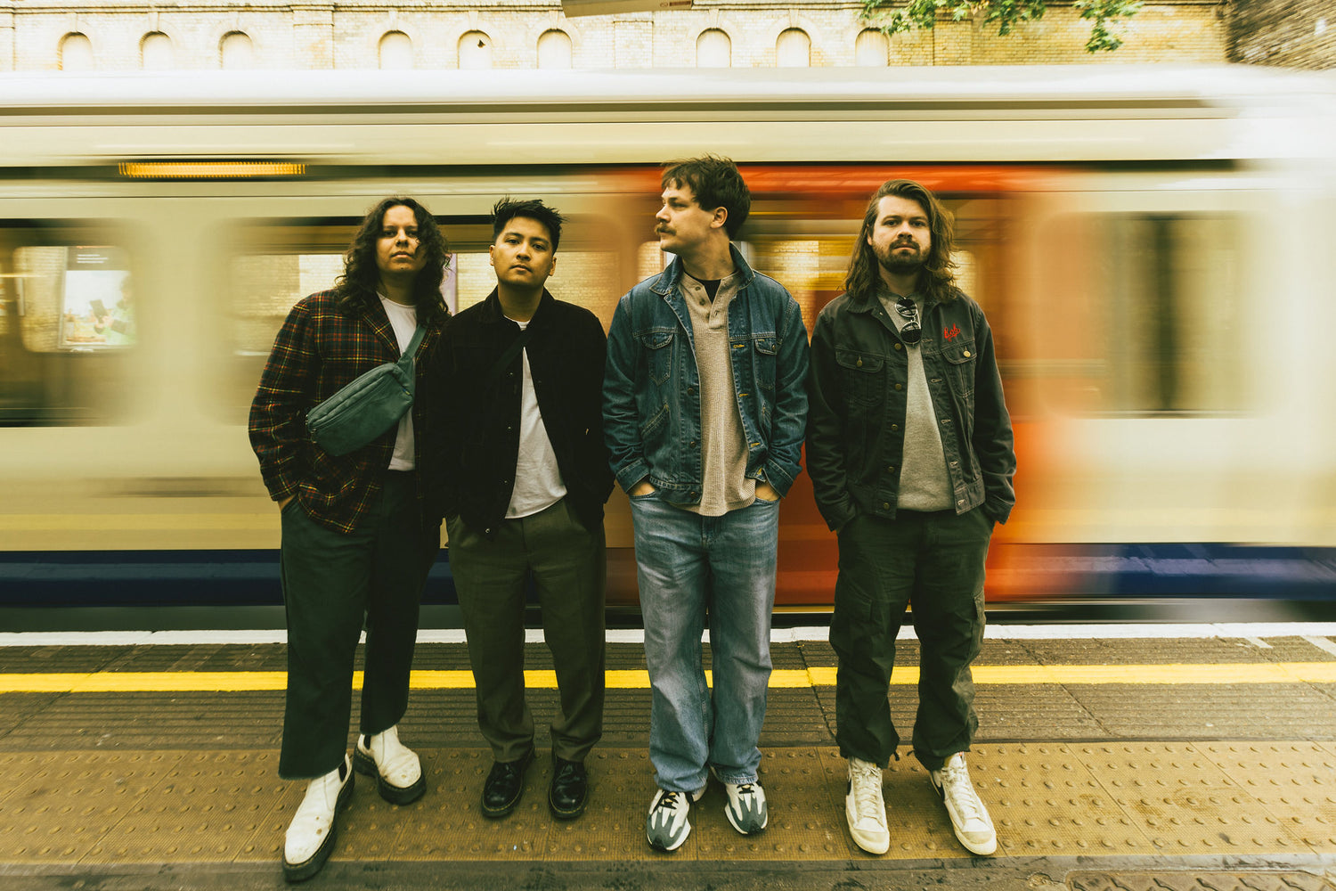 a group of men standing in front of a train